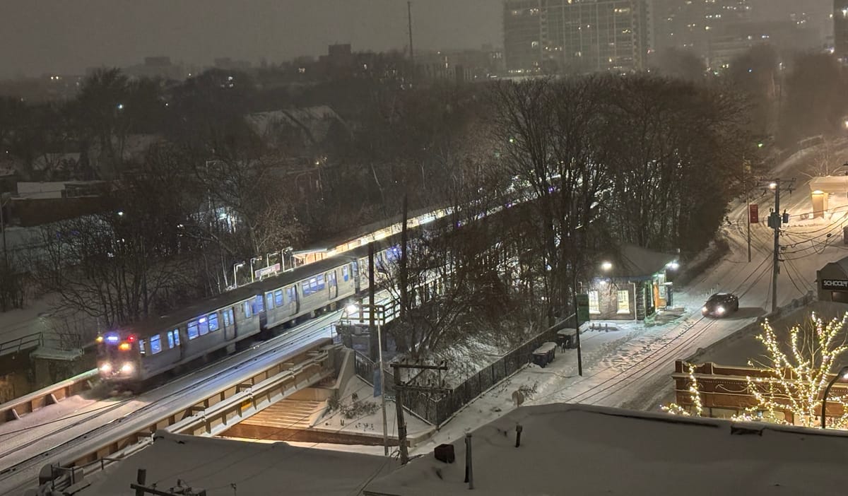CTA Purple Line Train leaving station after snowfall.