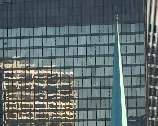 Tall building reflecting other buildings